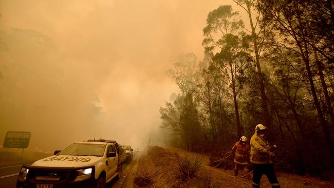 Firefighters BATTLE a bushfire at Moruya, south of Batemans Bay, in NSW. Picture: AFP.