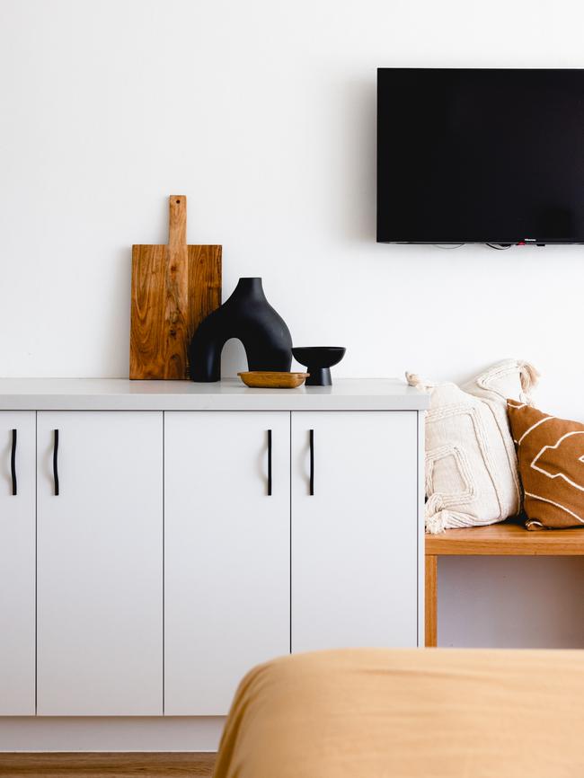 Rooms blend white, orange and black.