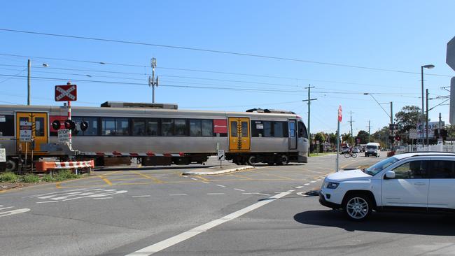 A train passes through the notorious Lindum rail crossing. Picture: Damian Bathersby