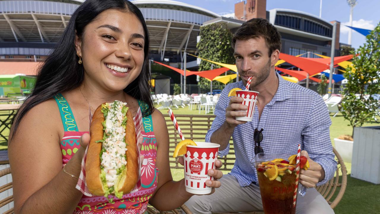 Daphne Albanese and Jonty Millar enjoying a $24 lobster roll and a Pimms at the Village Green at Adelaide Oval ahead of the Test. Picture: Kelly Barnes