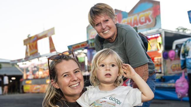 Kathleen Leggatt with son Koa Koland, 3, and mum Di Leggatt in sideshow alley at the Toowoomba Royal Show, Thursday, March 30, 2023. Picture: Kevin Farmer