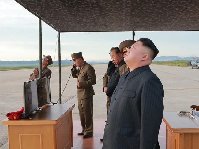 Kim Jong-un watches as a medium-and-long range strategic ballistic rocket Hwasong-12 successfully lifts off. Picture: KCNA via KNS