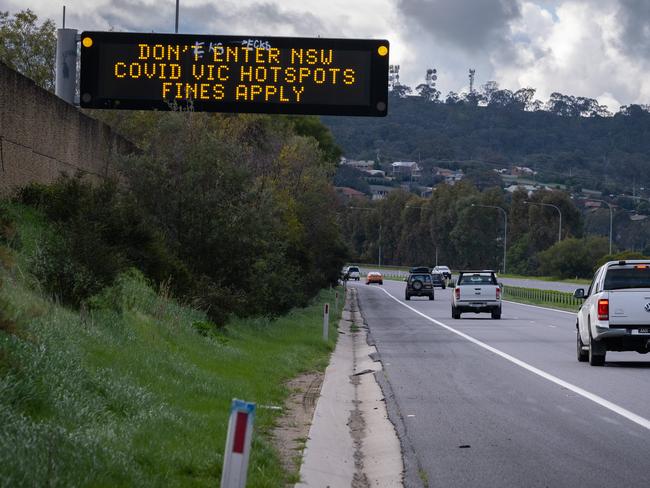 A sign on the Hume Hwy near the Murray River Border crossing into Albury NSW warns people not to enter NSW. Picture: Simon Dallinger.