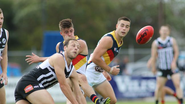 Port's SANFL captain Cameron Sutcliffe attempts to smother Riley Knight. Picture: AAP Image/Russell Millard)