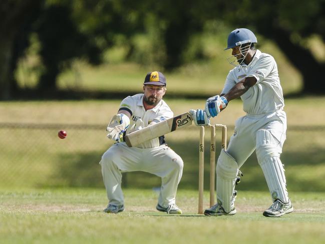 Long Island batsman Pubudu Edirisinghe cuts as Main Ridge keeper Mick Holmes looks on. Picture: Valeriu Campan