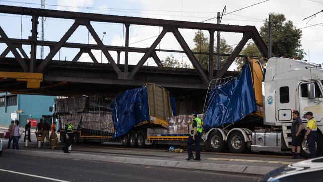 Truck stuck under the rail bridge near Boundary Rd.