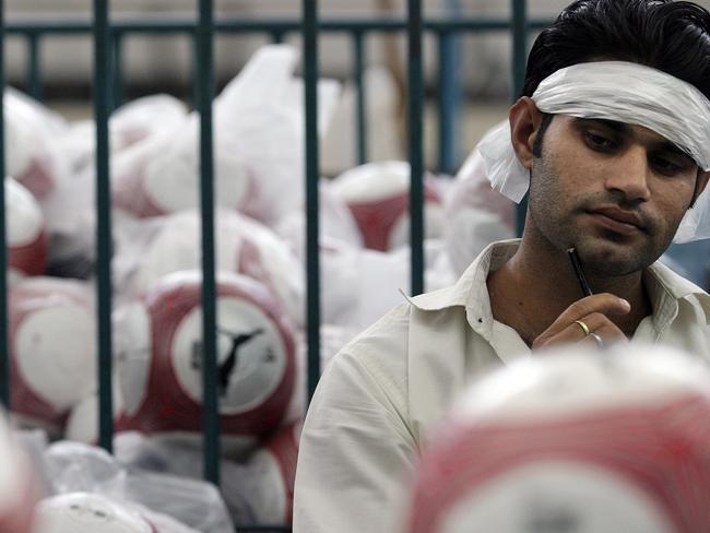 A worker at the Saga football factory in 2006.