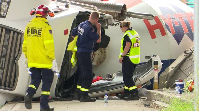 Emergency services working around the cabin of the truck, where one man was trapped by his legs. Picture: TNV