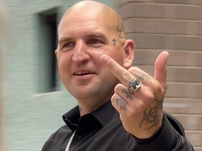 An alleged neo-Nazi extremist has admitted to intimidating and assaulting a Black Lives Matter activist in his Arncliffe home. Desmond Liddington â who has distinctive tattoos on his body and bald head, including an AK-47 gun with the word RAHOWA â appeared in Sutherland Local Court on Tuesday where he pleaded guilty to two charges. Liddington was charged with stalking/intimidation and affray charges after he and two others allegedly went to the home of Black Lives Matter activist Padraic âPaddyâ Gibson on December 4, 2021 in Arncliffe and used unlawful violence towards him. Pictured with his girlfriend. Picture: Ashleigh Tullis