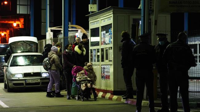 People speak to officials at Romania’s border with Ukraine in Sighetu Marmatiei. Picture: Andreea Campeanu/Getty Images