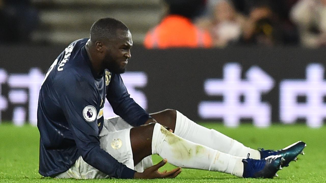Manchester United's Belgian striker Romelu Lukaku goes down after he trod on the ball and lost his balance