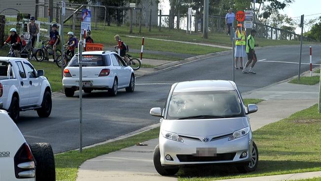 Police are starting to hand out parking infringements to parents parking and driving in dangerous ways around the Burpengary Meadows State School during pick up. Picture: Bradley Cooper