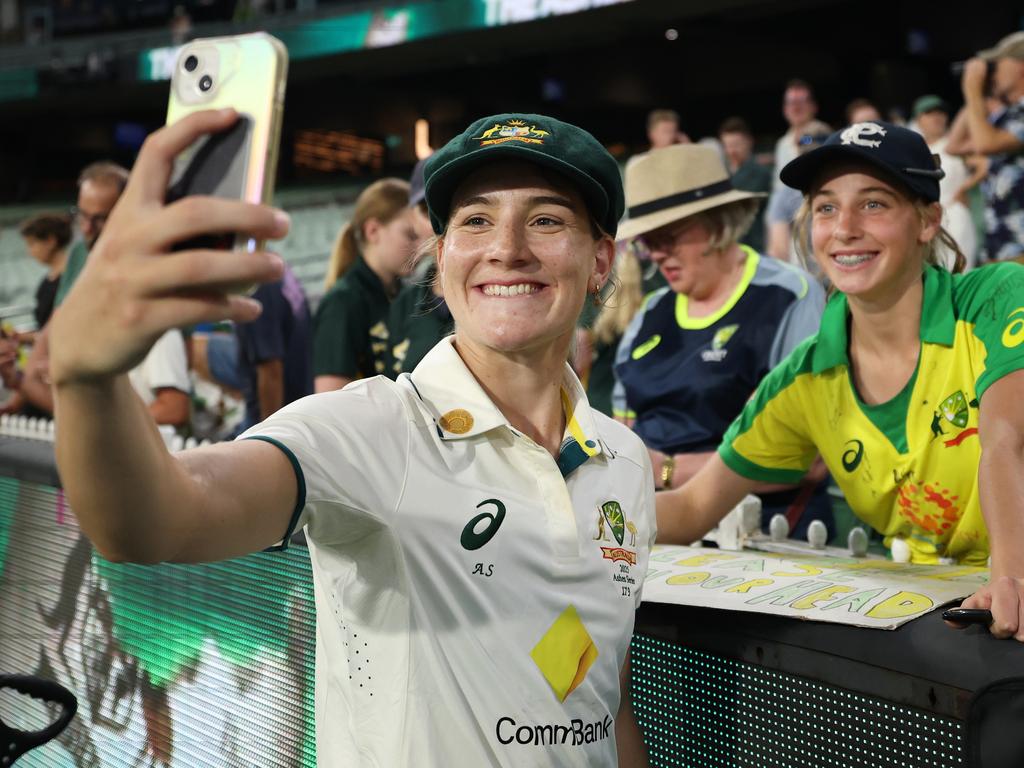 Annabel Sutherland celebrates with the MCG crowd after her century on Friday. (Photo by Daniel Pockett/Getty Images)