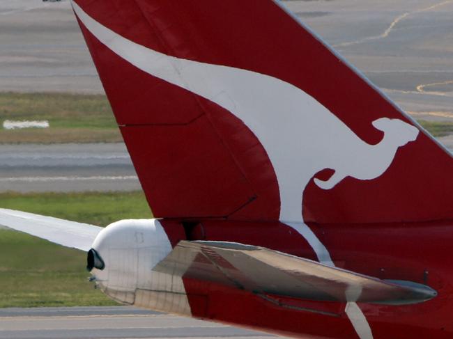 Flying Kangaroo logo on tail of a Qantas jet at International Airport in Sydney.