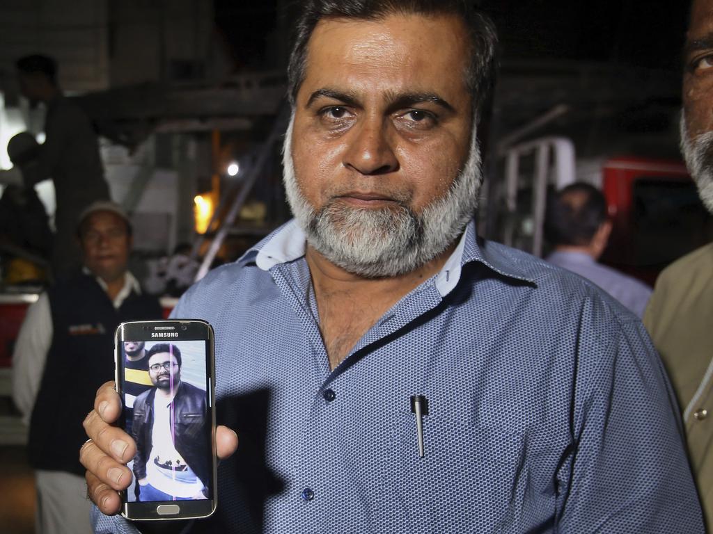 A relative shows the picture of Syed Areeb Ahmed, a Pakistani citizen who was killed the Christchurch mosque shooting, on his cell phone outside his home in Karachi, Pakistan. Picture: Fareed Khan