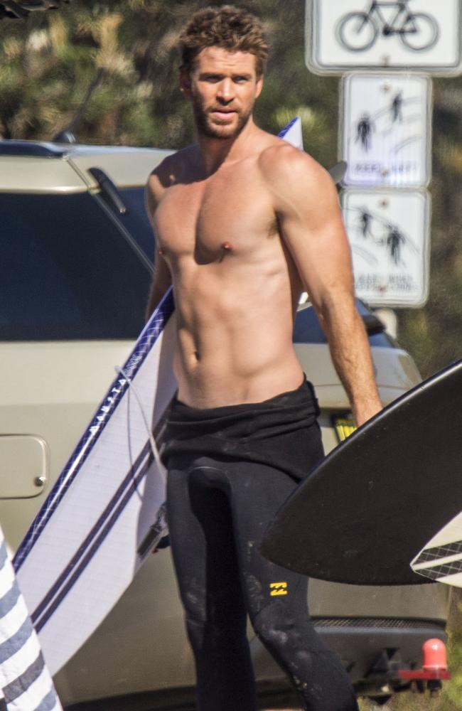 Hunger Games star Liam revealed a perfectly flat stomach before his morning surf. Picture: Media-Mode