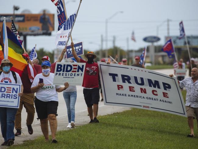 Biden and Trump supporters walk side-by-side in Florida. Picture: Angus Mordant for NewsCorp Australia