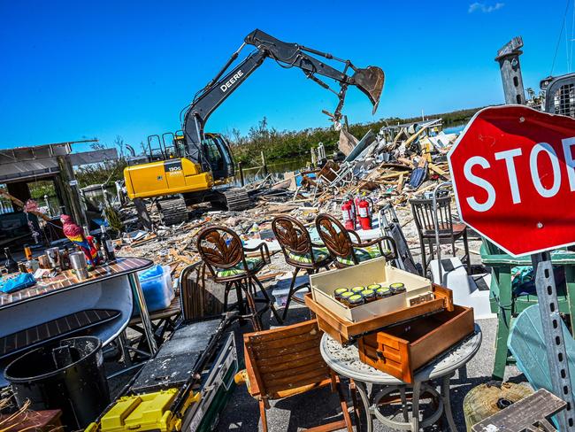 Workers and residents clear debris from a destroyed bar on San Carlos Island in Fort Myers after Hurricane Ian hit Florida. Picture: AFP