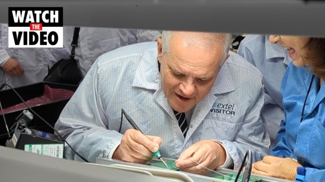 PM Scott Morrison works on a motherboard