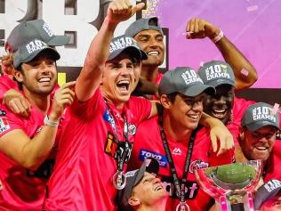 SYDNEY, AUSTRALIA - FEBRUARY 06: The Sixers celebrate victory with the trophy after winning the Big Bash League Final match between the Sydney Sixers and the Perth Scorchers at the Sydney Cricket Ground on February 06, 2021 in Sydney, Australia. (Photo by Hanna Lassen/Getty Images)