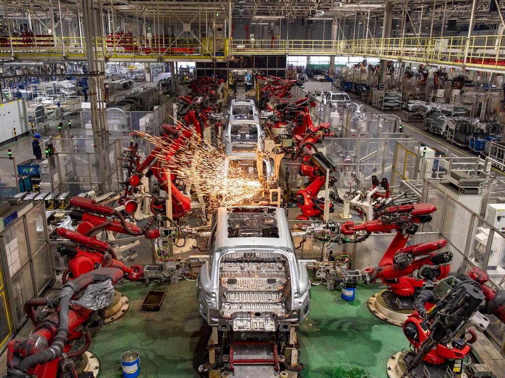 Robotic arms work at an intelligent factory of EV enterprise Leapmotor. Picture: Getty