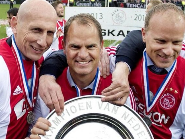 Ajax manager Frank de Boer (C) with assistants Jaap Stam (L) and Dennis Bergkamp (R) after the club won the title this year. De Boer and Bergkamp played under van Gaal.