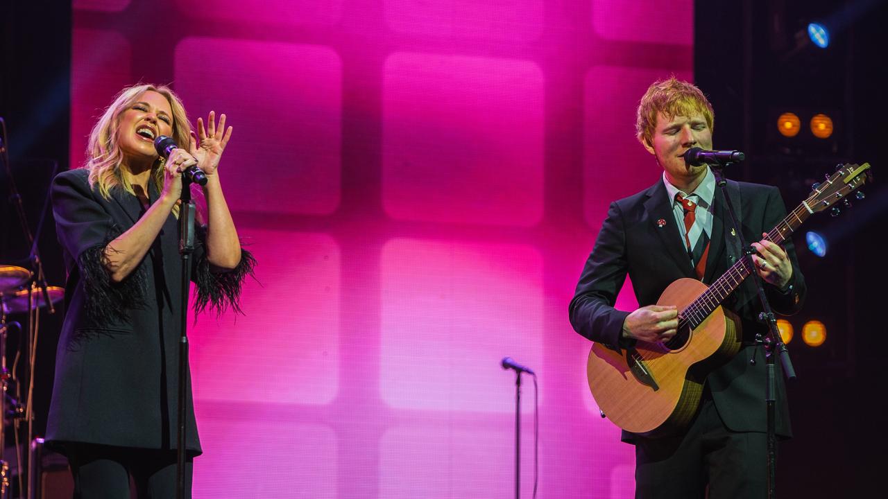 Kylie Minogue and Ed Sheeran play a tribute song to Michael Gudinski at the State Memorial Service. Picture Mushroom Creative House.