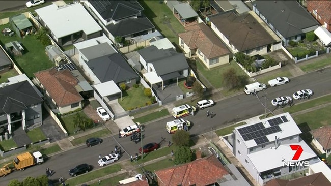 Police descend on Osgood St near Woodville Rd at Guildford. Picture: 7News