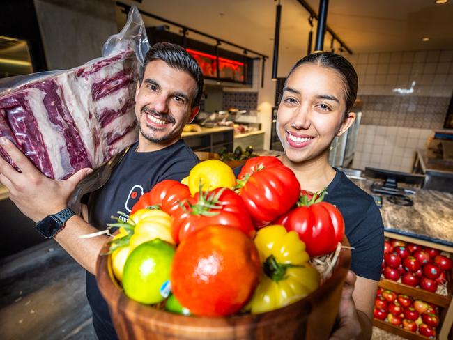 Nikos Chatzopolous and Maria Paula Gonzalez get set for the opening of Il Mercato Italian mega market. Picture: Jake Nowakowski