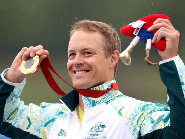 PARIS, FRANCE - SEPTEMBER 07: Gold medalist, Curtis Mcgrath of Team Australia celebrates on the podium during the Para Canoe - Men's Kayak Single 200m - KL2 medal ceremony on day ten of the Paris 2024 Summer Paralympic Games at Vaires-Sur-Marne Nautical Stadium on September 07, 2024 in Paris, France. (Photo by Steph Chambers/Getty Images)