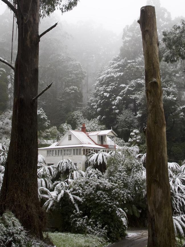 The snow covered house in winter.