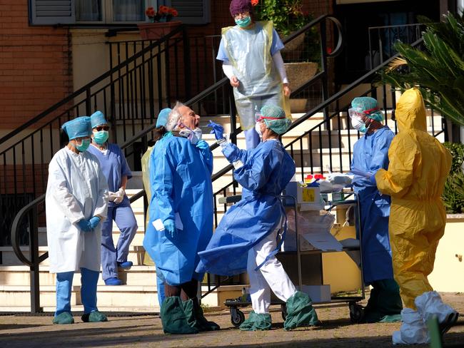 Medical personnel at a retirement home in Rome undergo coronavirus tests after the death of a patient. Picture: AP