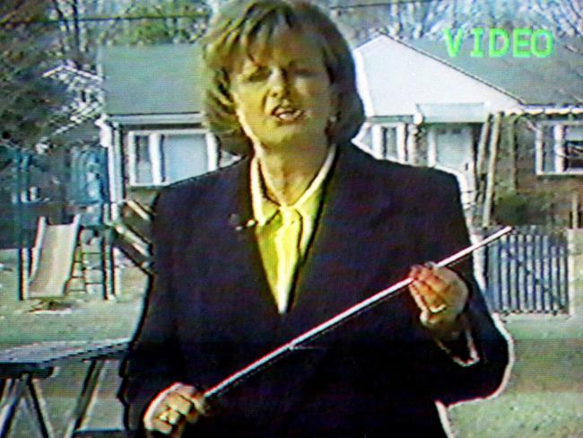 A scene from 1999 US documentary on Twelve Tribes Mission shows the presenter with a plastic rod used to beat children.