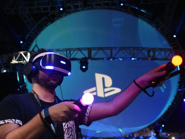 People try the new Sony VR headset at the Sony PlayStation E3 event. Picture: AFP/Robyn Beck