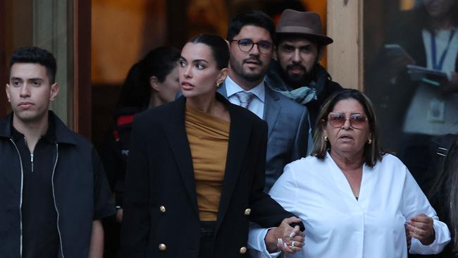 Spanish model and wife of Dani Alves, Joana Sanz (2L), holding hands with his mother Lucia Alves (2L) and his brothers (back), leave on the second day of the Brazilian footballer’s trial at the High Court of Justice of Catalonia in Barcelona. (Photo by LLUIS GENE / AFP)