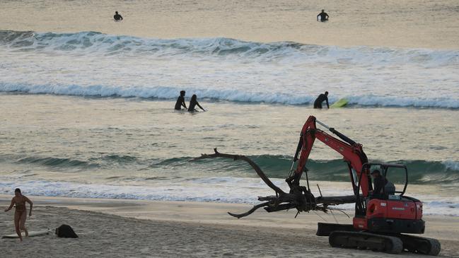 Waverley Council have enlisted an excavator to help remove flood debris from Bondi Beach early Thursday. Picture: John Grainger