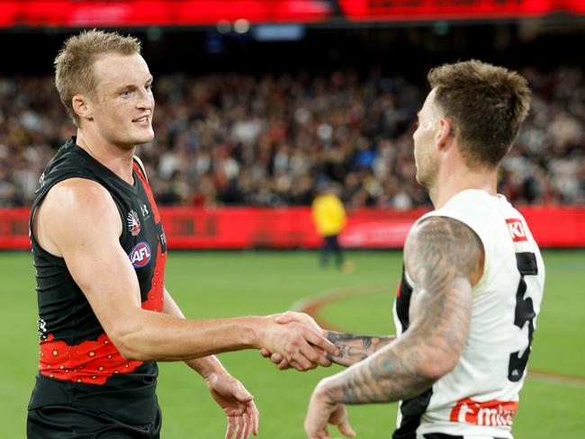 MELBOURNE, AUSTRALIA – APRIL 25: Jamie Elliott of the Magpies and Mason Redman of the Bombers shake hands after the game ends in a draw during the 2024 AFL Round 07 match between the Essendon Bombers and the Collingwood Magpies at the Melbourne Cricket Ground on April 25, 2024 in Melbourne, Australia. (Photo by Dylan Burns/AFL Photos via Getty Images)