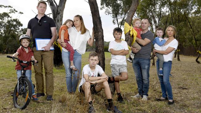 Belair National Park Action Group members (L-R) Sands Butterworth with son Wilson, 6, Danielle Blanchette with daughter Olive, 4 and sons Sid, 13 and Beau, 11 and Kym Evans and partner Leanne Hurley and sons Jayden, 2 and Nathan, 4 with trees that would be cleared under a controversial development plan. Picture: Naomi Jellicoe