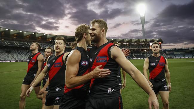 Darcy Parish and Jake Stringer embrace after their big win at GMHBA Stadium.