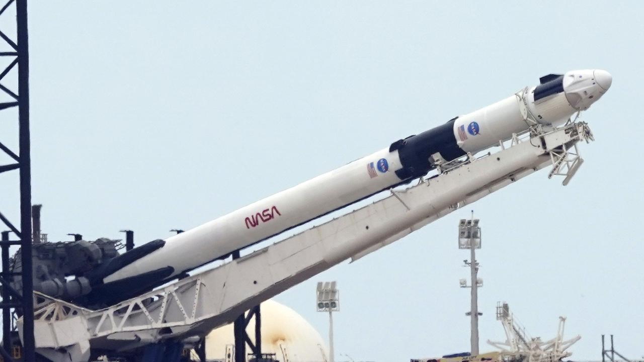 The SpaceX Falcon 9, with the Crew Dragon spacecraft on top of the rocket being raised onto its launch pad on Tuesday. Picture: AP Photo / David J. Phillip