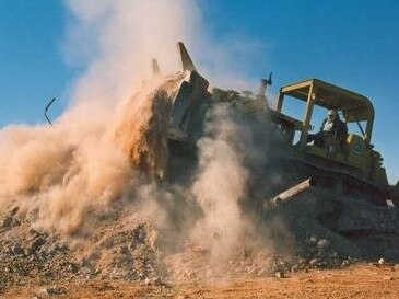 Brian McFarlane operating a Caterpillar D9G bulldozer in Andamooka. Picture: Supplied