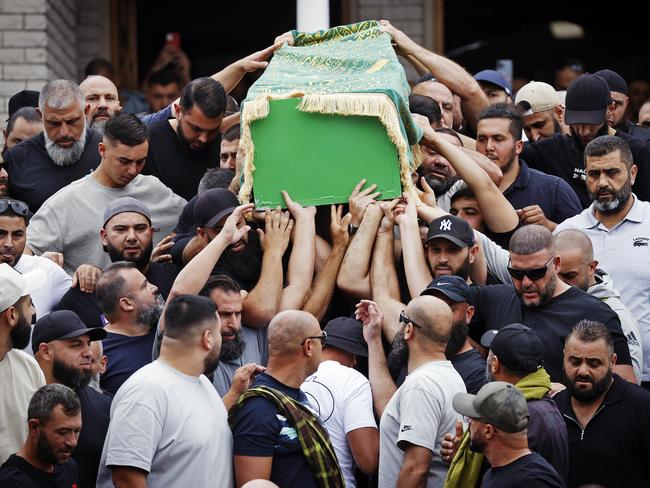 Mourners carry the green casket outside Lakemba Mosque today. Picture: Sam Ruttyn