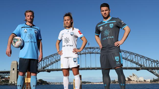 Sydney FC football players (l-r) Rhyan Grant, Angelique Hristodoulou and Alex Baumjohann model their new playing kits on Wednesday. Picture: Brett Costello