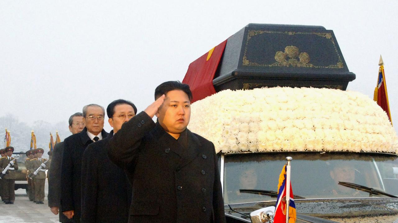 Kim Jong-un standing behind his father’s casket in 2011. Picture: Handout / KCNA / AFP.