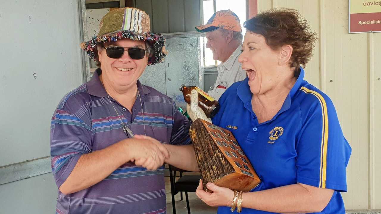 NEW CHAMPIONS: President of the Rotary Club Glen Hay hands over the trophy to the Lions Club, represented by Julianne Shipway. Picture: Contributed