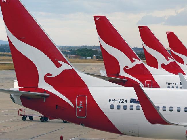 MELBOURNE, AUSTRALIA - FEBRUARY 25:  Qantas aeroplanes wait at Melbourne Tullamarine Airport on February 25, 2014 in Melbourne, Australia. On Thursday Qantas will announce their half year results, media reports suggest part of those announcements will include a large number of job cuts and the sale of their Melbourne terminal.  (Photo by Scott Barbour/Getty Images)