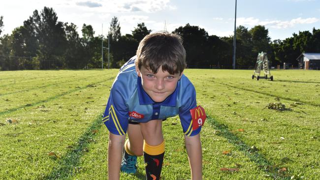 Hayden Austin, 8, takes a crouch start for a sprint.