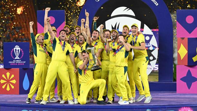 Australia's players celebrate with the trophy after winning the 2023 ICC Men's Cricket World Cup. (Photo by Sajjad HUSSAIN / AFP)