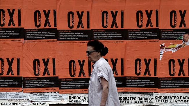 Decision time ... A woman walks past posters reading 'NO' ahead of the referendum this weekend on bailout conditions. Picture: Aris Messinis/AFP