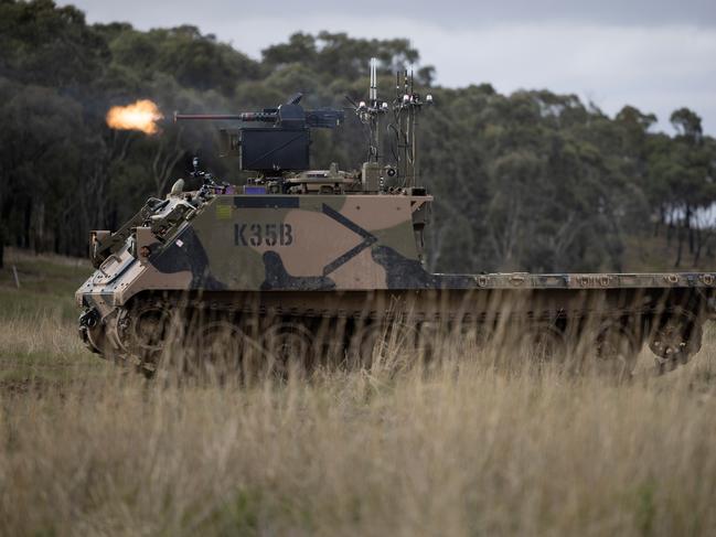 An Australian Army M113AS4 armoured logistics vehicle, fitted with optionally crewed combat vehicle technology and a remote weapon station, fires from a support-by-fire position during a human-machine team exercise at Puckapunyal Military Area. *** Local Caption *** The Australian Army’s Robotic and Autonomous Systems Implementation & Coordination Office (RICO) conducted a human-machine team exercise at Puckapunyam Military Area on Thursday, 7 June, 2023. The aim was to converge several RICO emerging technology projects into a simulated future warfare environment. Autonomous drones, robots, and optionally crewed combat vehicles fitted with remote weapon systems worked within a conventional combined arms team in defeating a simulated enemy. The activity showed how human-machine teams can help minimise potential harm to soldiers.